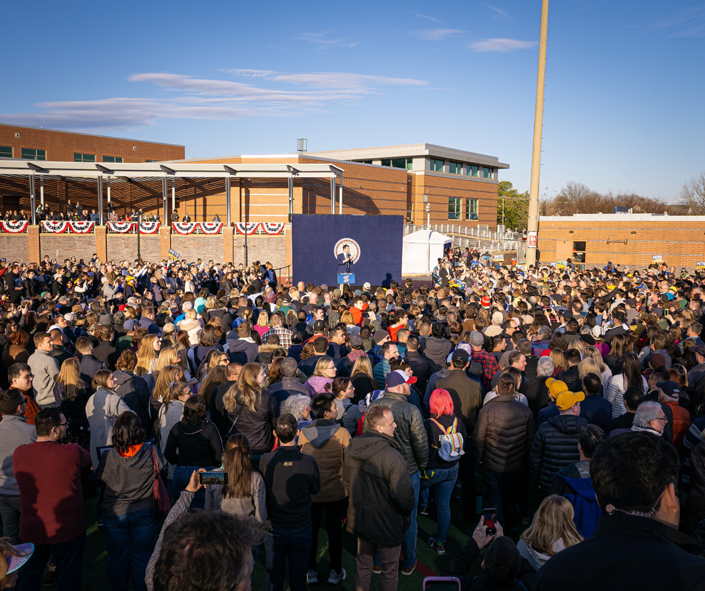 a crowd of education reform advocates gathering at a school