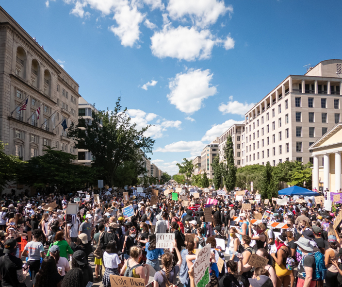 a crowd of parents and educators rallying